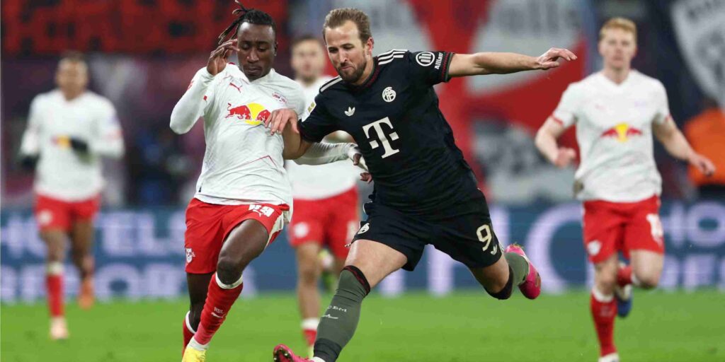 Yan Diomande in a battle for the ball with Harry Kane