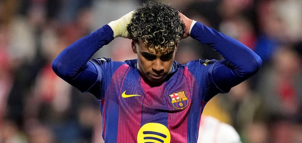 Lamine Yamal holding his head after missing a scoring chance