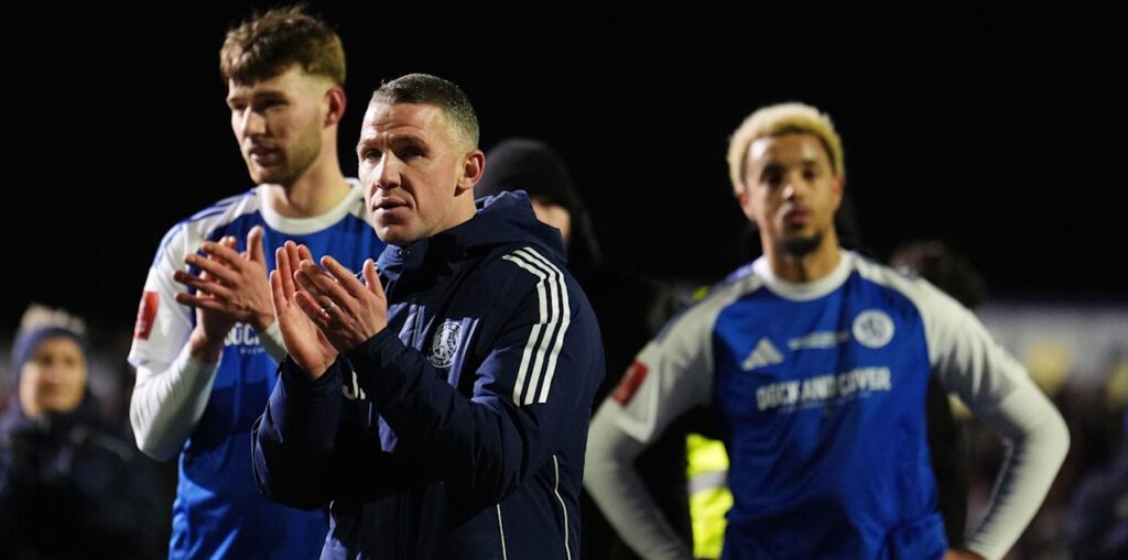 Macclesfield players and manager applaud the fans after losing to Brentford in FA Cup