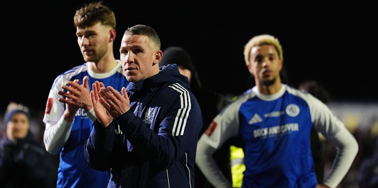 Macclesfield players and manager applaud the fans after losing to Brentford in FA Cup