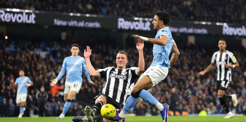 Newcastle defender trying to stop Omar Marmoush