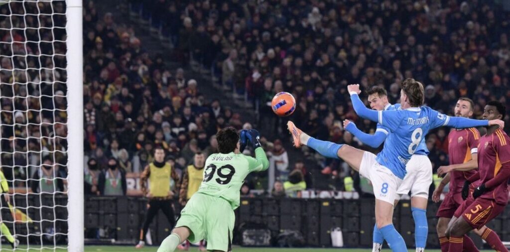 Roma goalkeeper Svilar punching the ball away