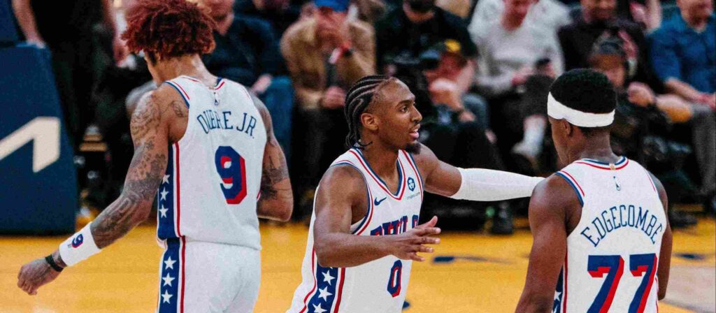 Tyrese Maxey talking to VJ Edgecombe