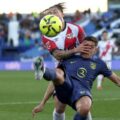 Rayo Vallecano player bringing down an Atletico Madrid opponent