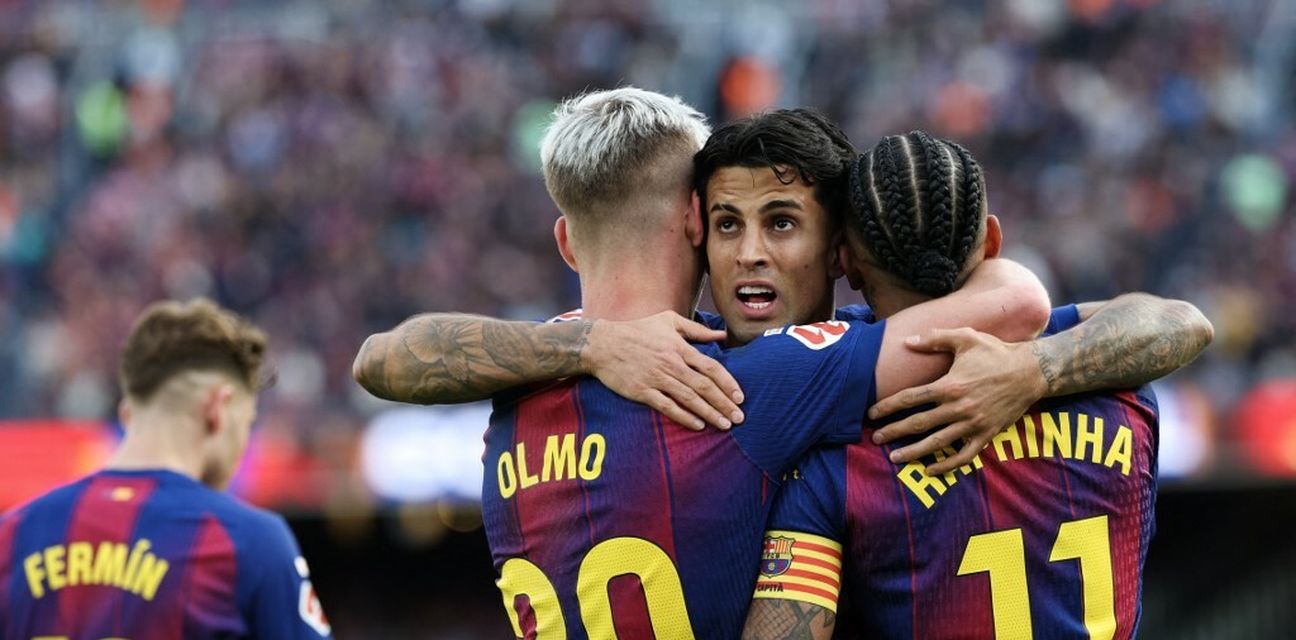 Barcelona players celebrate after scoring against Sevilla