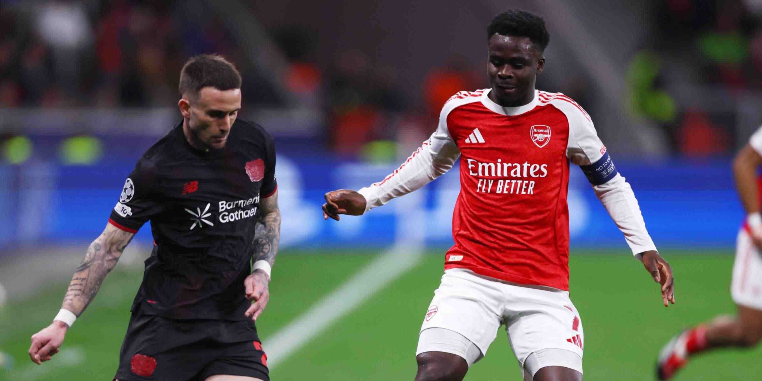 Bayer Leverkusen and Arsenal players in a battle for the ball