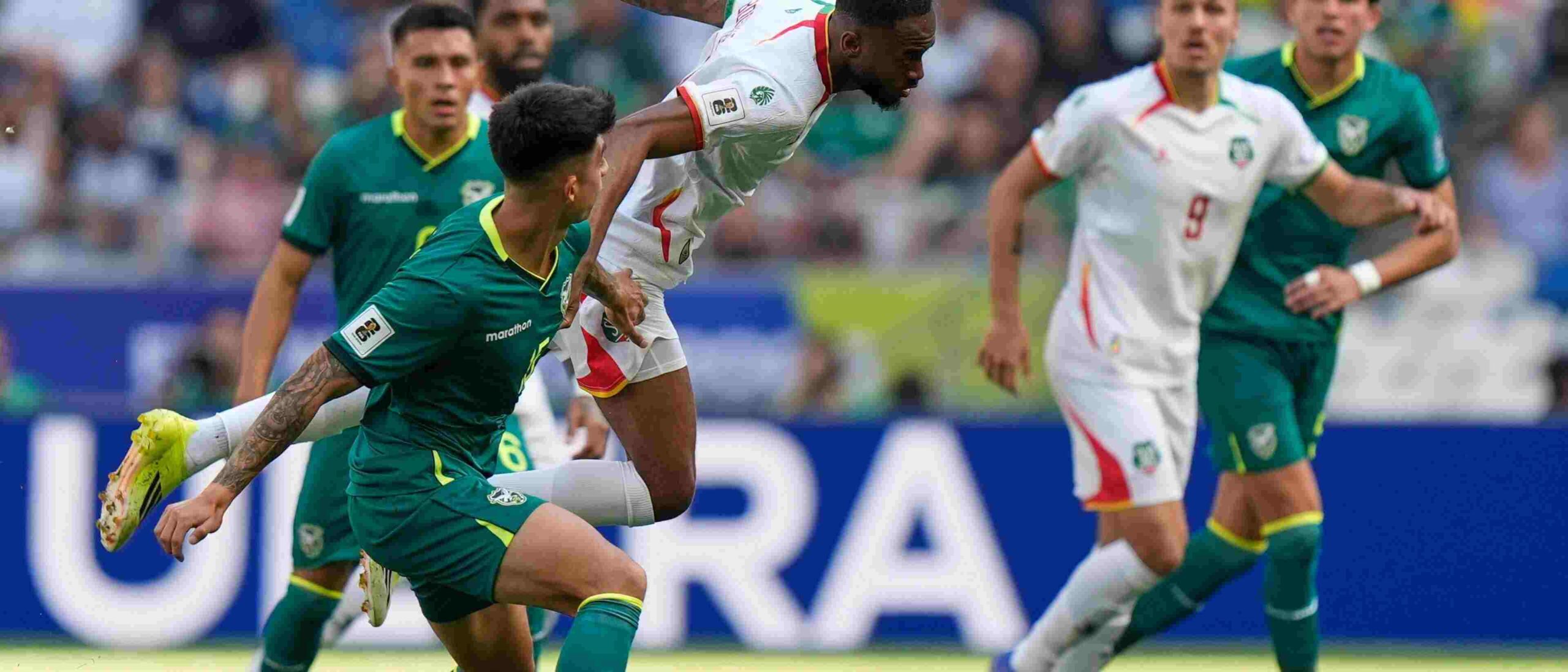Bolivia and Suriname players battling for the ball