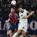 Bologna and Roma players in an aerial duel