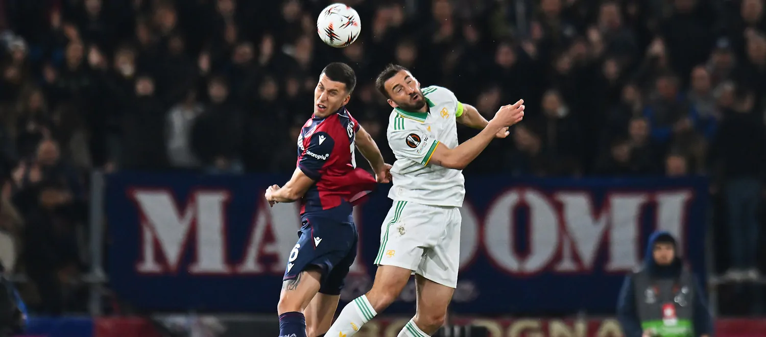 Bologna and Roma players in an aerial duel