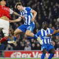 Brighton and Arsenal players jumping for a high ball