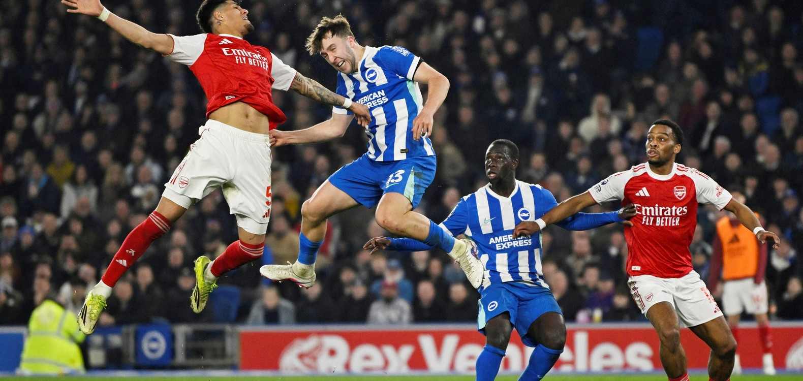 Brighton and Arsenal players jumping for a high ball