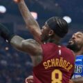 Dennis Schroeder guarded by a Dallas Mavericks player