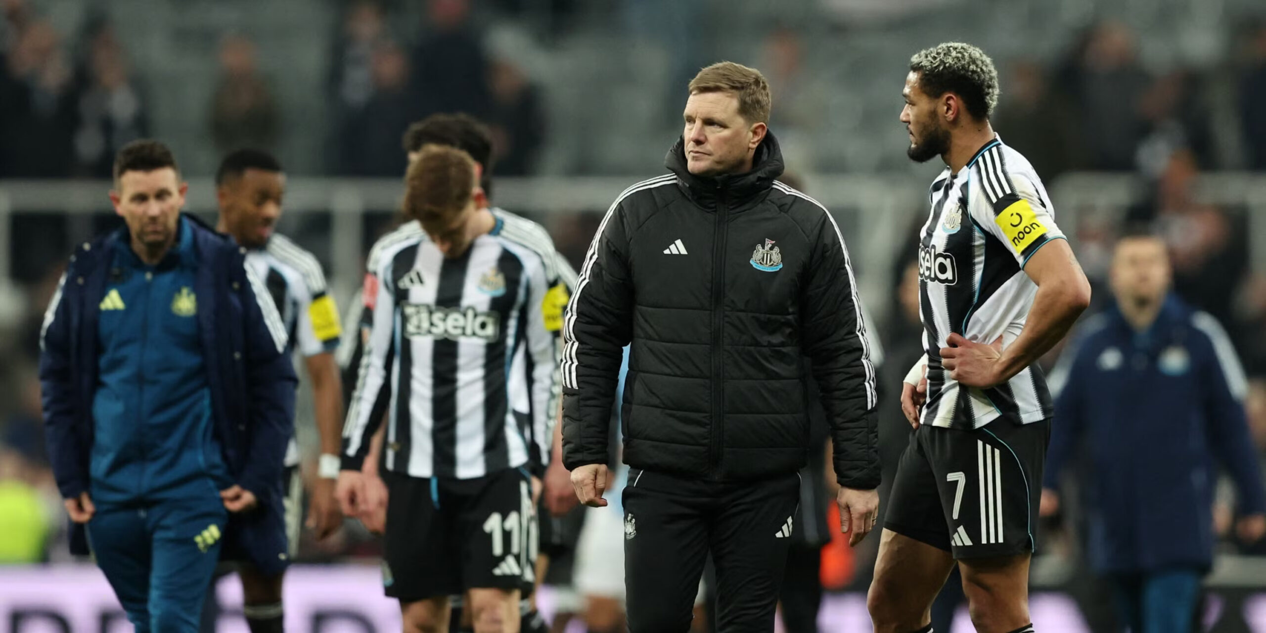 Newcastle manager Eddie Howe surrounded by a couple of players