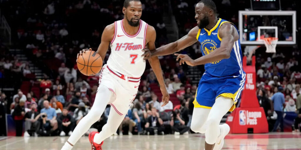 Kevin Durant trying to dribble past Draymond Green