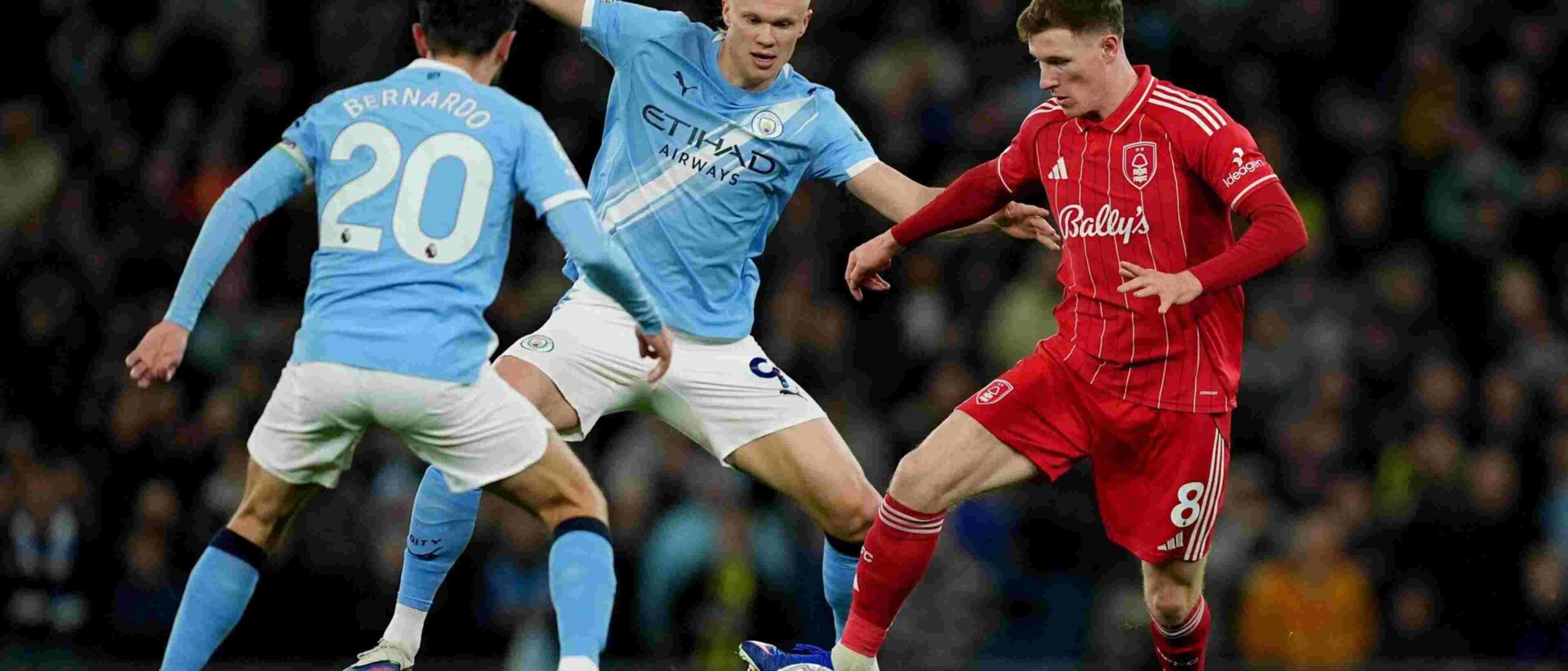 Erling Haaland and Bernardo Silva in a battle for the ball with Elliot Anderson
