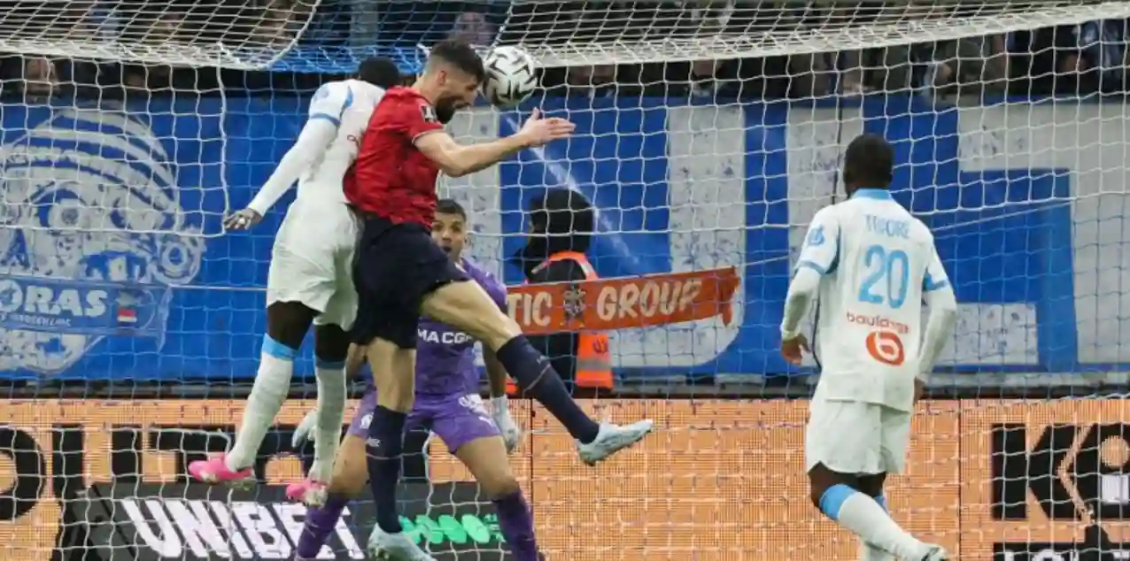 Lille player heads the ball towards Marseille's net