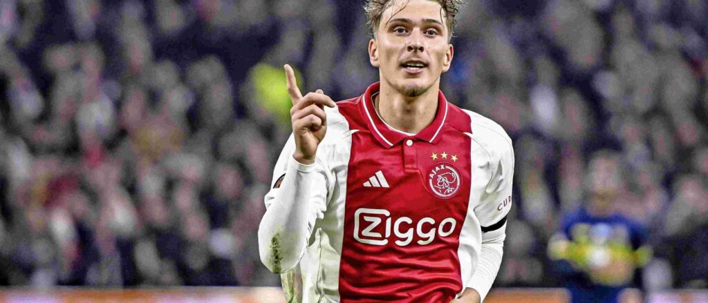 Ajax winger Mika Godts celebrates after scoring a goal