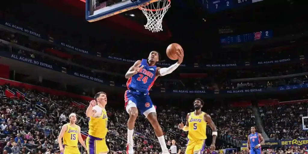Daniss Jenkins scoring an easy basket against Los Angeles Lakers