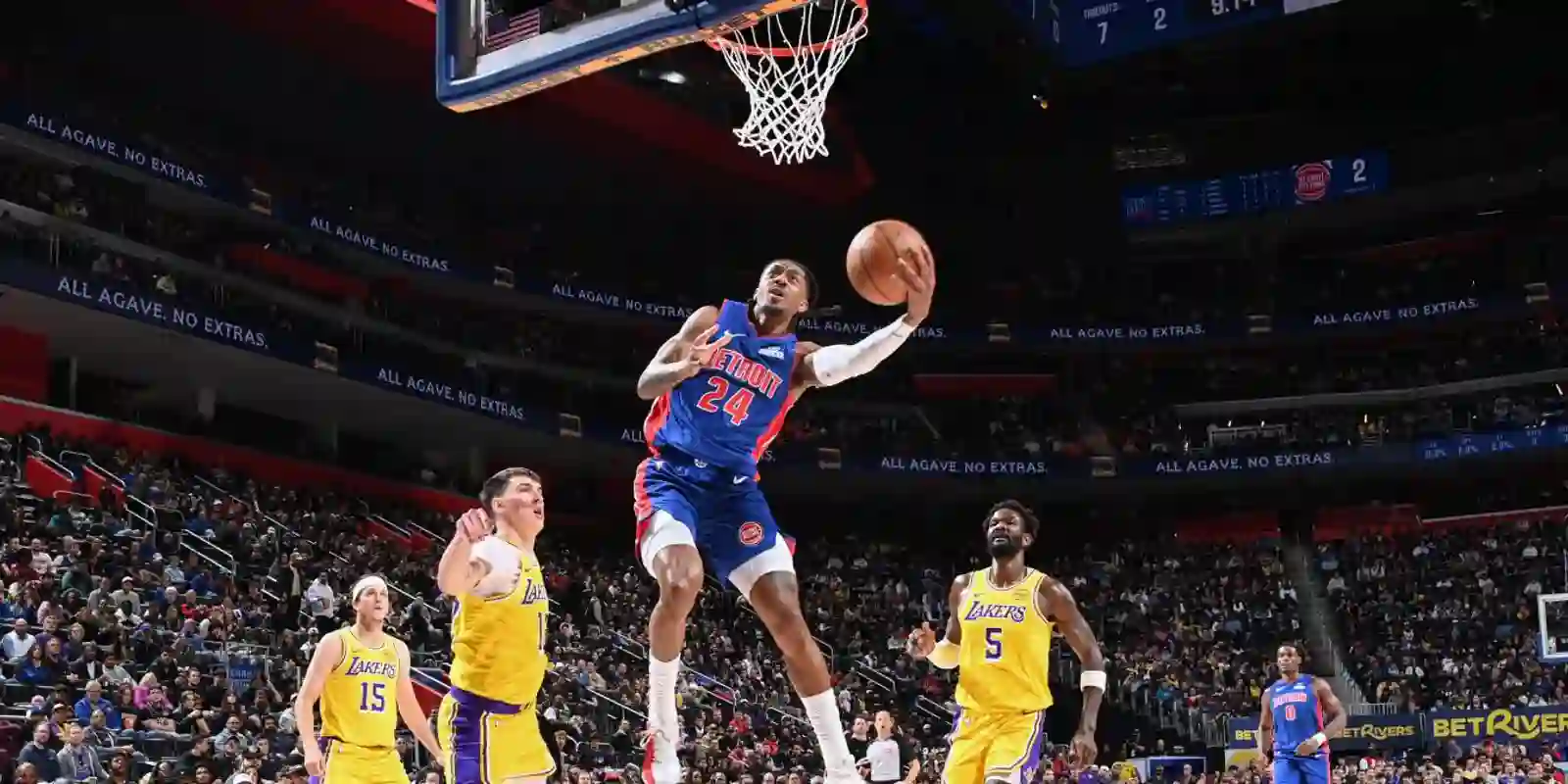 Daniss Jenkins scoring an easy basket against Los Angeles Lakers