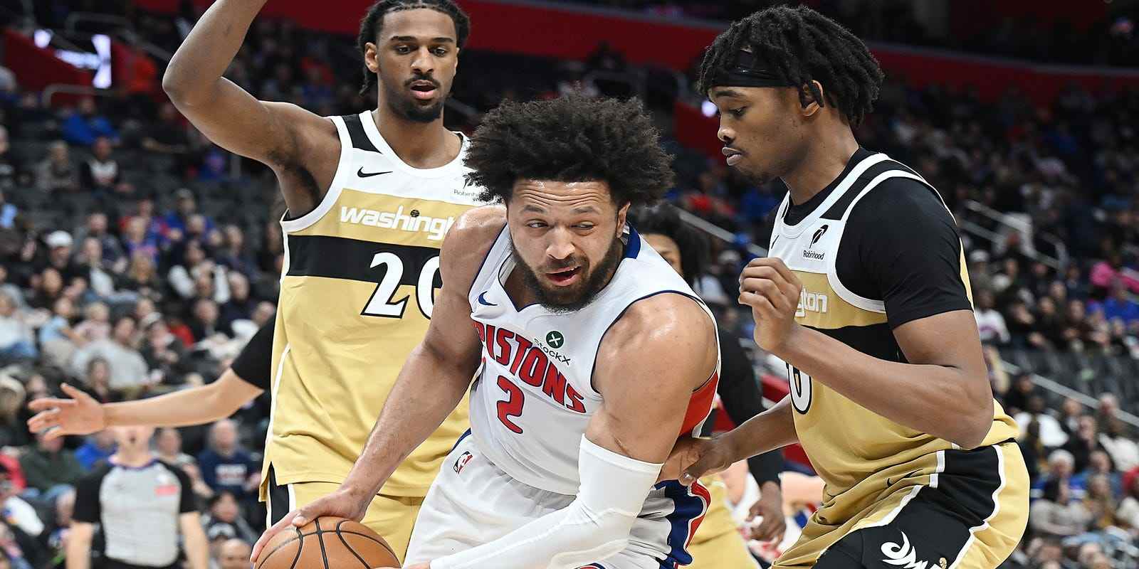 Cade Cunningham guarded by multiple Washington players