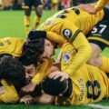 Wolves' players celebrate after scoring stoppage time winner against Liverpool