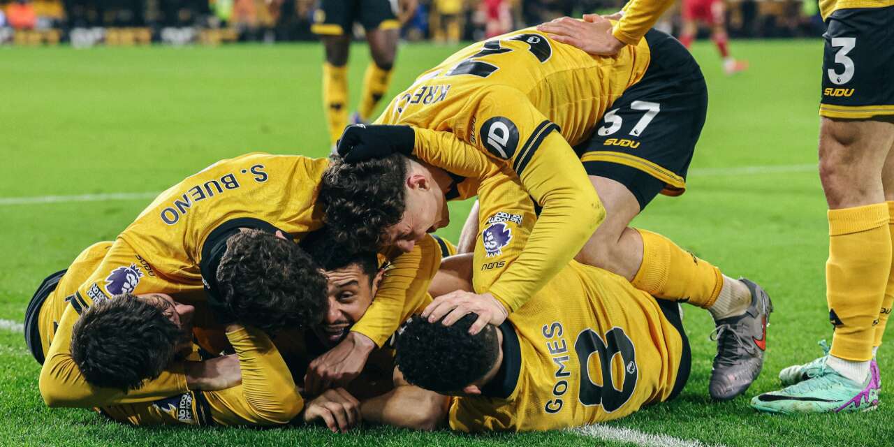 Wolves' players celebrate after scoring stoppage time winner against Liverpool