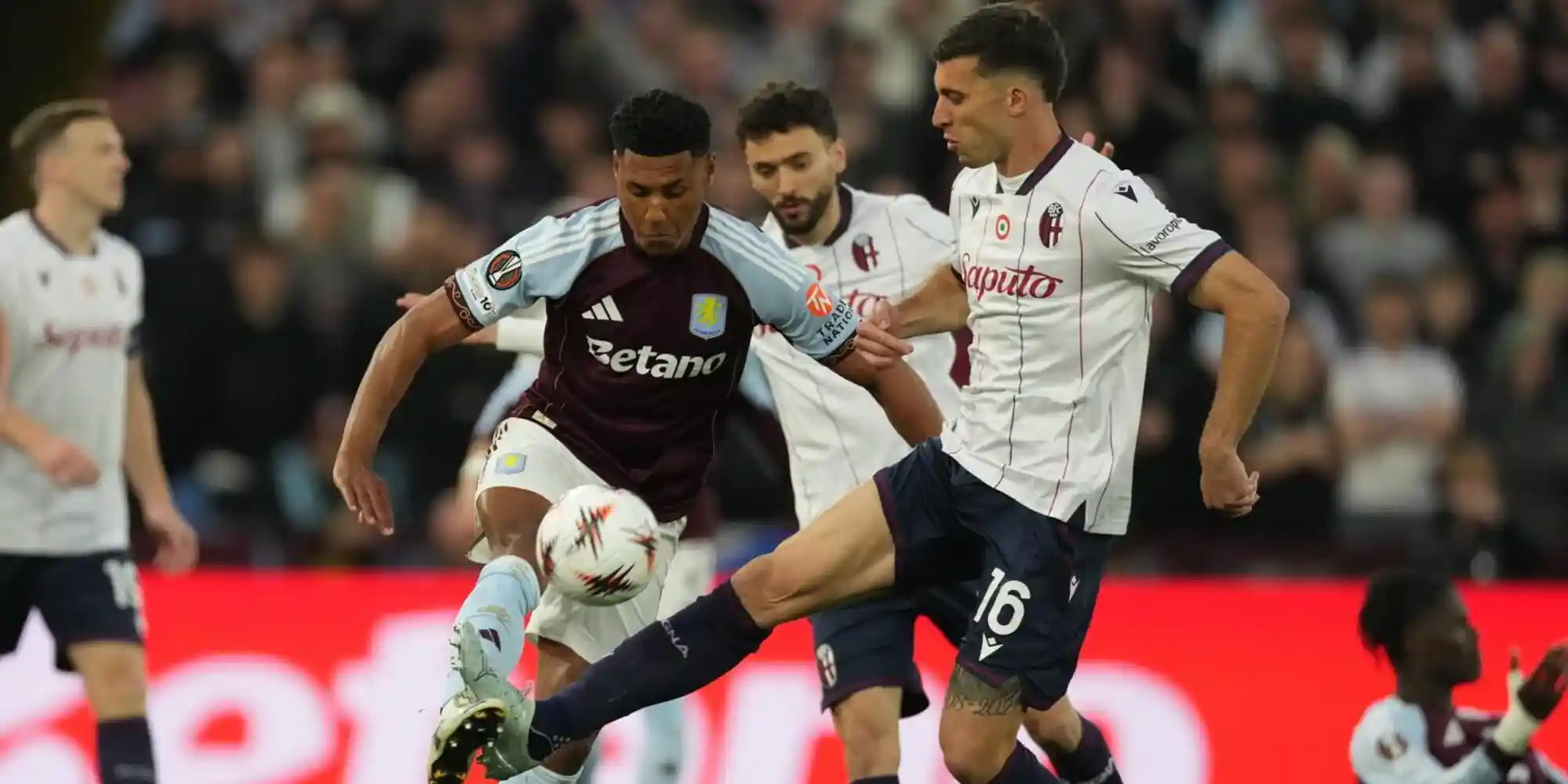 Aston Villa and Bologna players in a battle for the ball