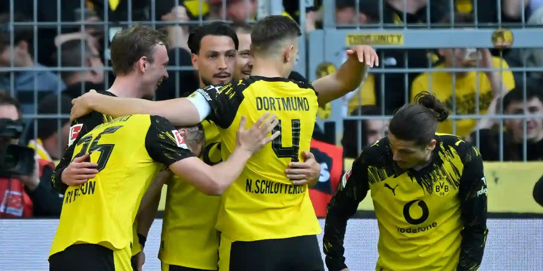 Borussia Dortmund players congratulate one another after scoring against Freiburg