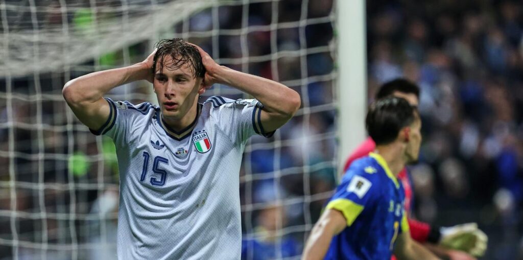 Italy striker Pio Esposito holding his head after missing a scoring chance against Bosnia & Herzegovina