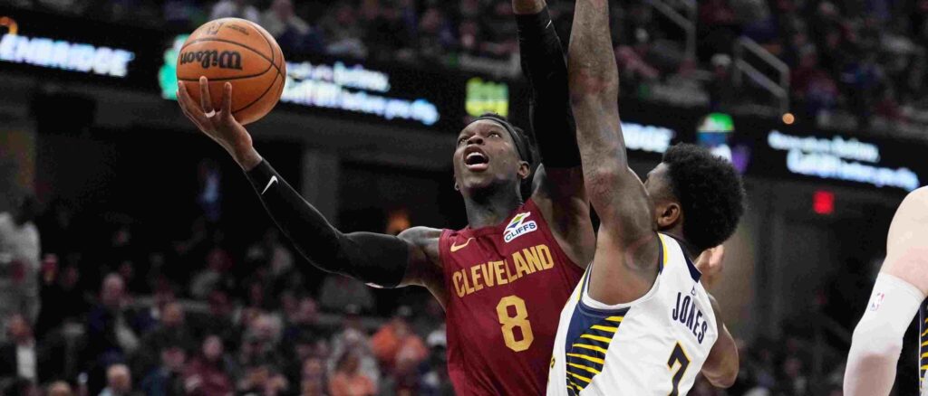 Dennis Schroder attempting to score in Indiana's basket