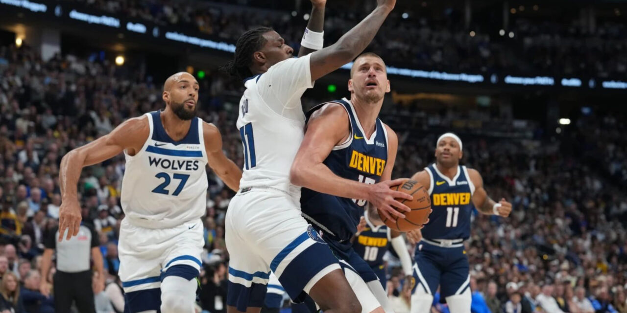 Nikola Jokic guarded by Minnesota Timberwolves player