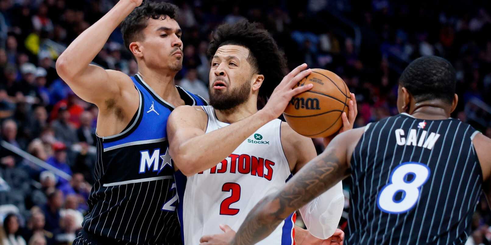 Cade Cunningham guarded by multiple Orlando players