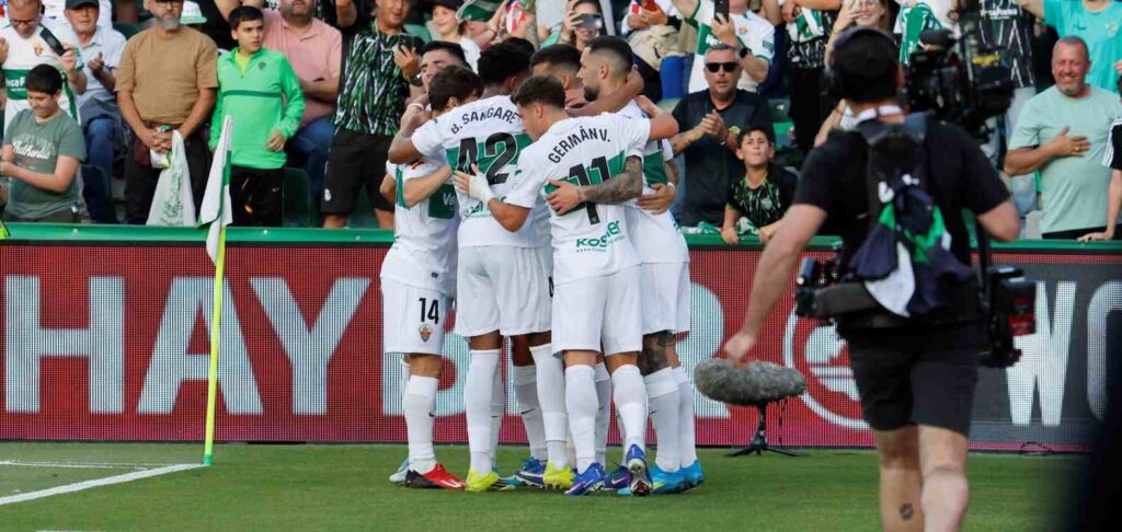 Elche players celebrate after scoring against Atletico Madrid