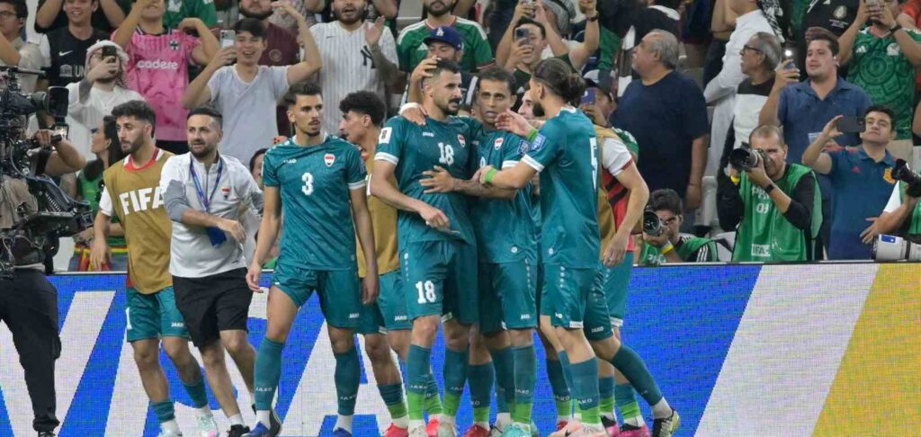 Iraq players celebrate after scoring against Bolivia