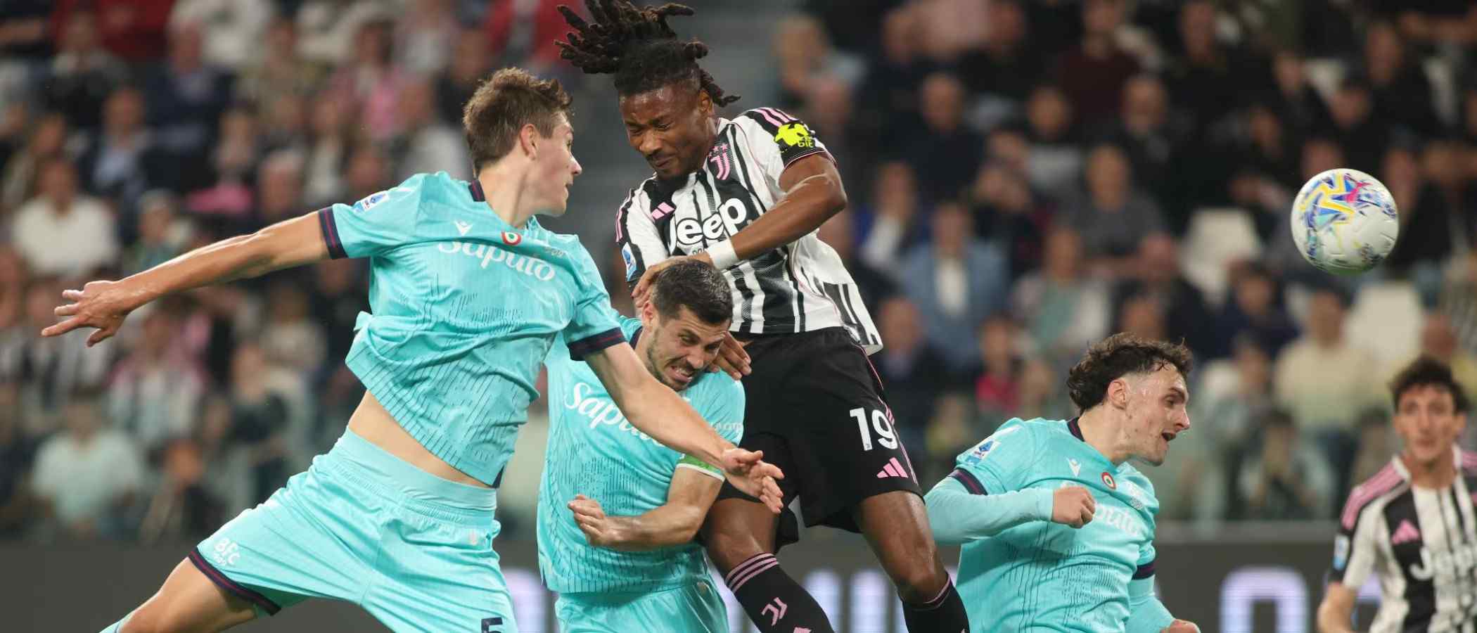 Juventus and Bologna players in a battle for a high ball