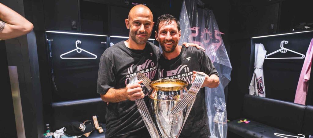 Javier Mascherano and Lionel Messi posing with Inter Miami trophy
