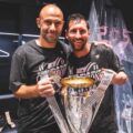 Javier Mascherano and Lionel Messi posing with Inter Miami trophy