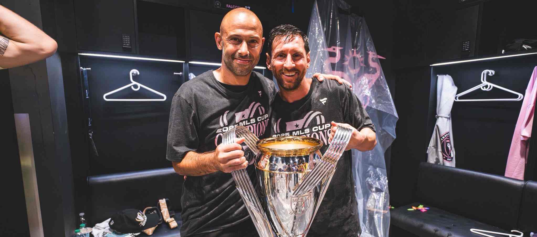 Javier Mascherano and Lionel Messi posing with Inter Miami trophy