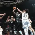 Minnesota Timberwolves players attacking Denver Nuggets' basket