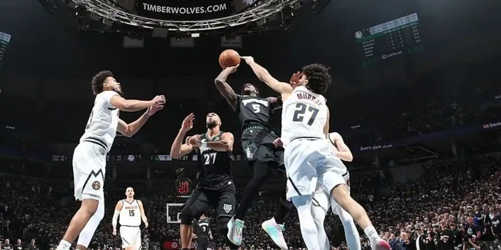 Minnesota Timberwolves players attacking Denver Nuggets' basket