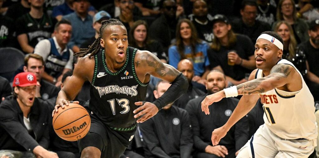 Bruce Brown watches as Ayo Dosunmu dribbles the ball