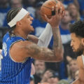 Paolo Banchero guarded by 2 Detroit Pistons players