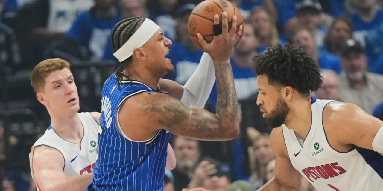 Paolo Banchero guarded by 2 Detroit Pistons players