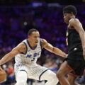 VJ Edgecombe watches as Desmond Bane dribbles the ball
