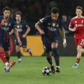 Desire Doue dribbles between Liverpool players