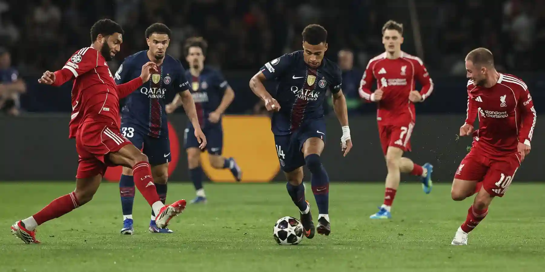 Desire Doue dribbles between Liverpool players