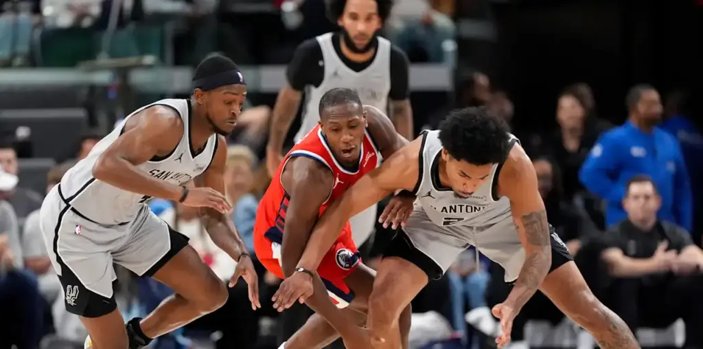 San Antonio Spurs and Los Angeles Clippers players in a battle for a loose ball