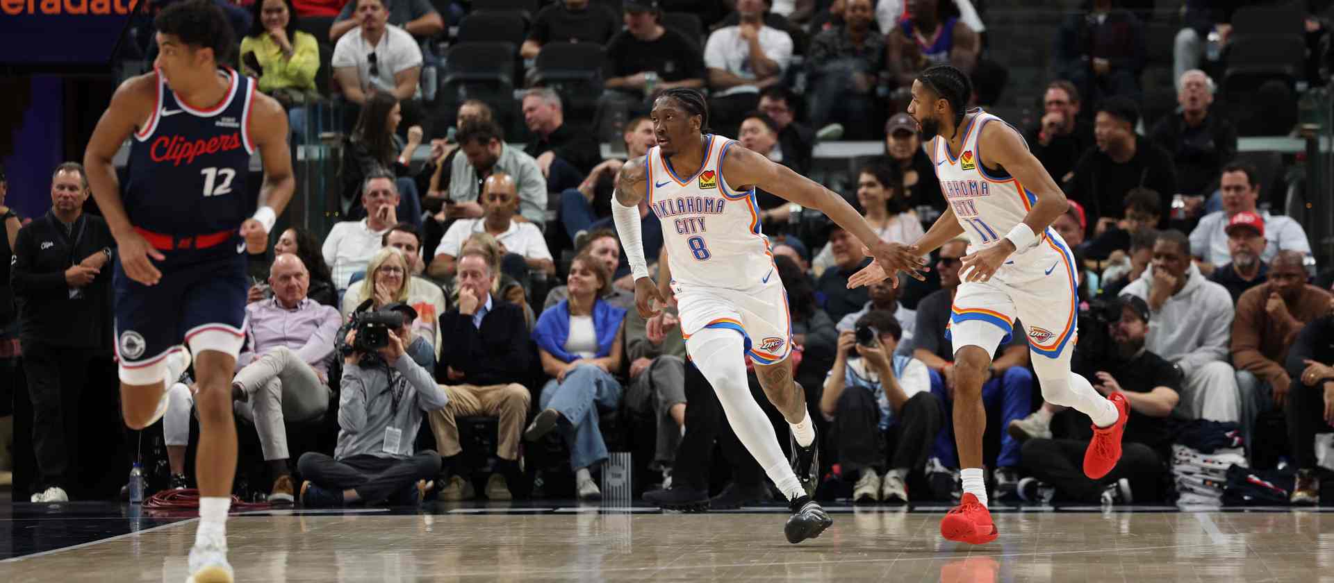 Oklahoma City Thunder players congratulating one another after scoring a basket against Los Angeles Clippers