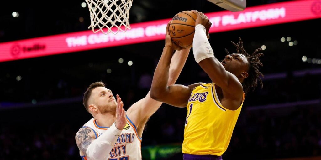 Isaiah Hartenstein trying to stop Los Angeles Lakers player from scoring