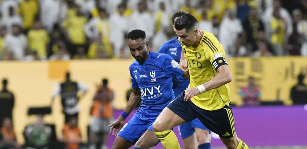 Cristiano Ronaldo trying to dribble past Al Hilal player